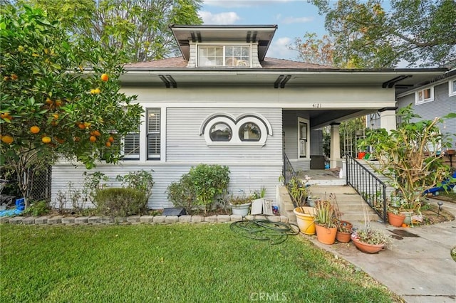 view of front of home with covered porch and a front yard