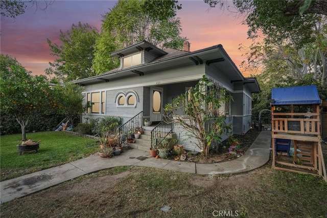 view of front of home with a lawn and a porch