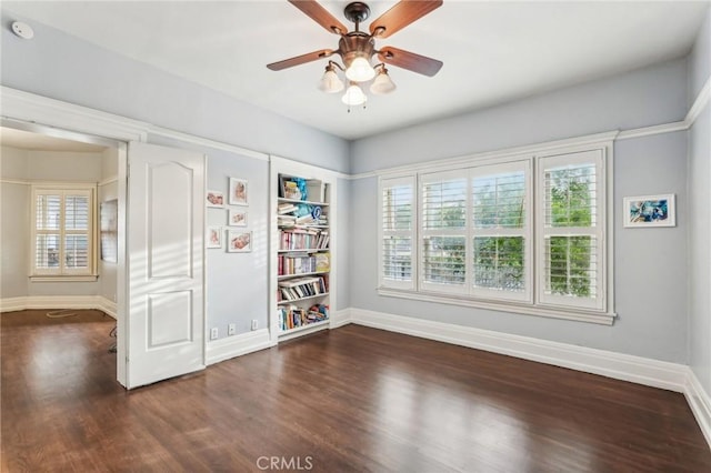 unfurnished room featuring ceiling fan and dark wood-type flooring