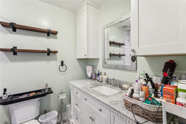 bathroom featuring vanity and toilet