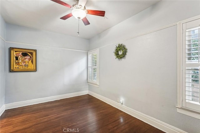 empty room featuring dark hardwood / wood-style floors and ceiling fan