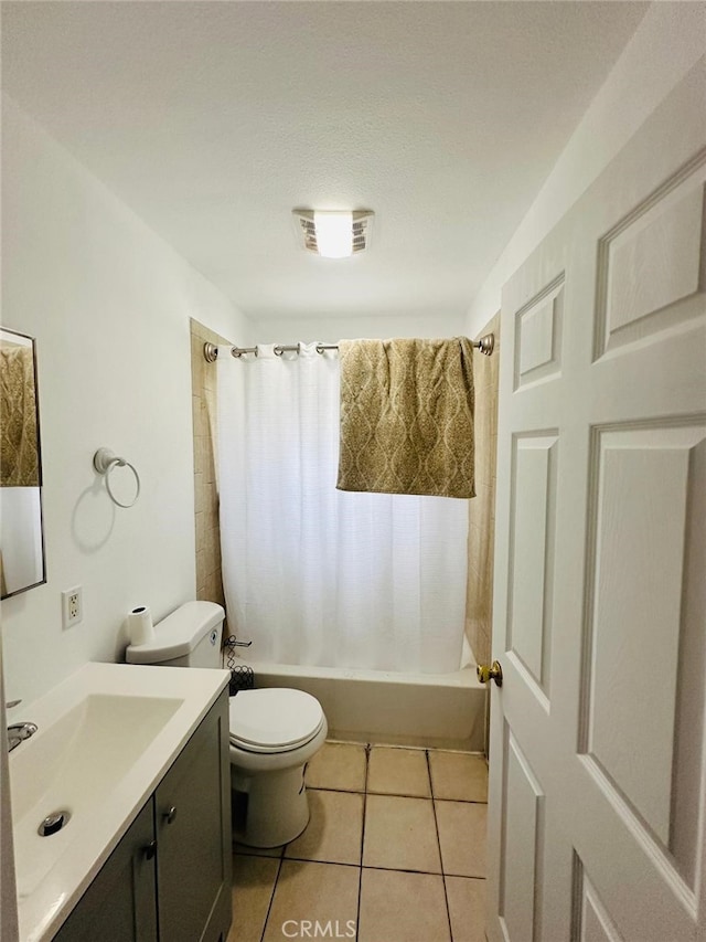 full bathroom featuring vanity, shower / bath combo with shower curtain, toilet, and tile patterned floors