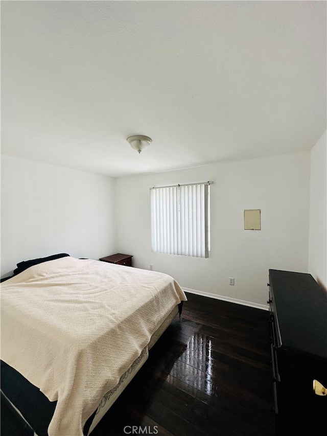 bedroom featuring dark hardwood / wood-style flooring