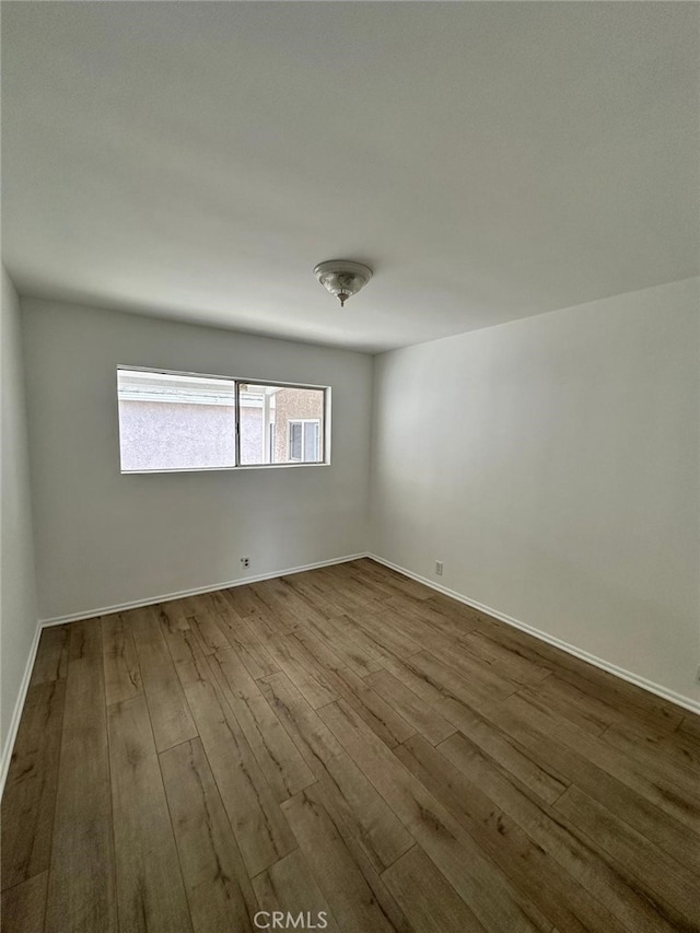 spare room with light hardwood / wood-style floors