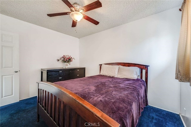 carpeted bedroom featuring ceiling fan and a textured ceiling