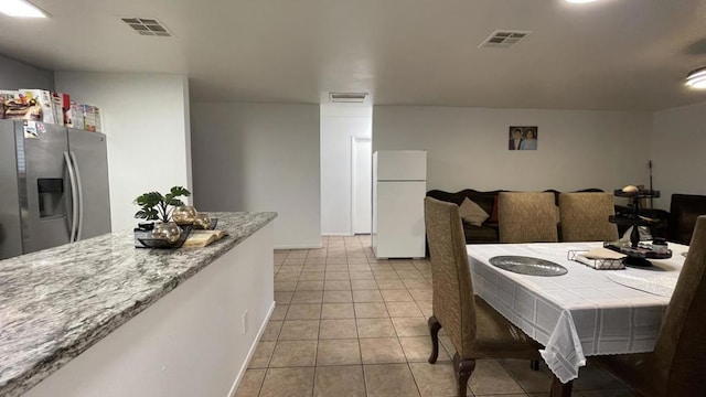 dining area featuring light tile patterned floors