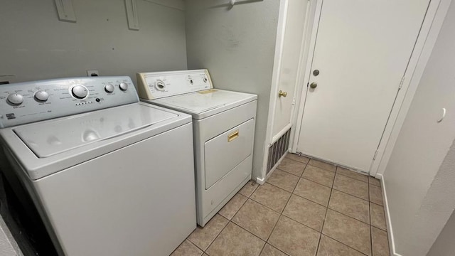 laundry room featuring light tile patterned flooring and washer and dryer