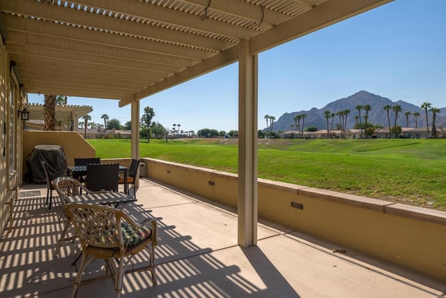 view of patio with a mountain view and a pergola