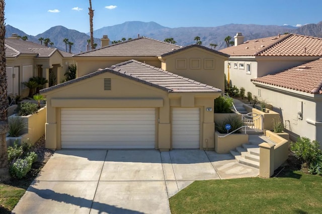 view of front of home with a mountain view and a garage