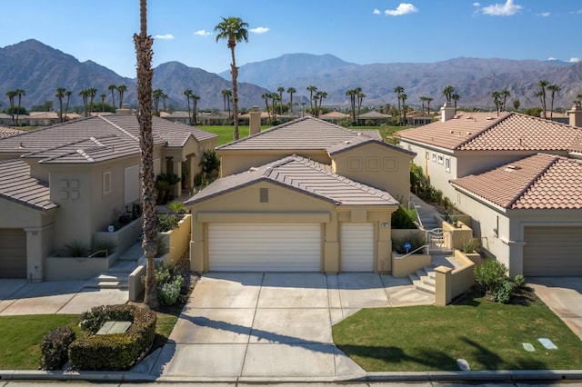 view of front of house with a mountain view and a garage