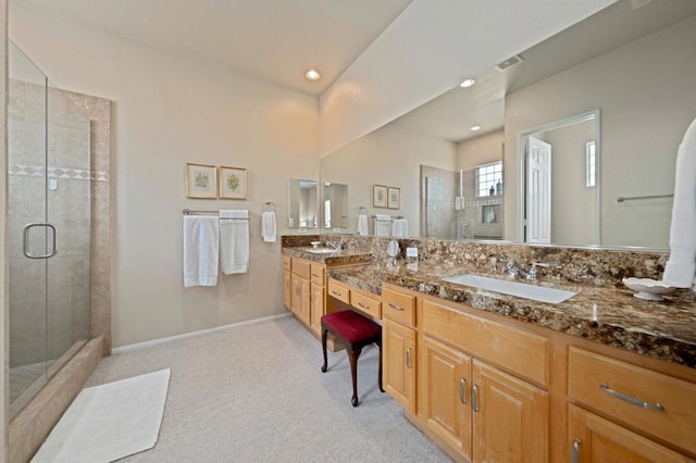 bathroom featuring vanity and an enclosed shower