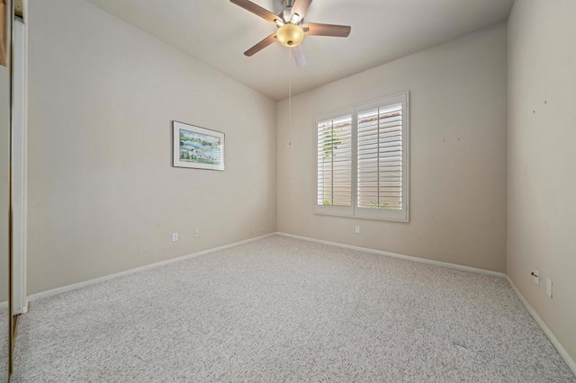 carpeted empty room featuring ceiling fan