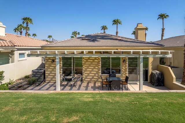 back of house with a yard, a patio, and central AC unit