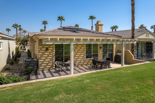 rear view of property featuring a patio area, a yard, and central air condition unit