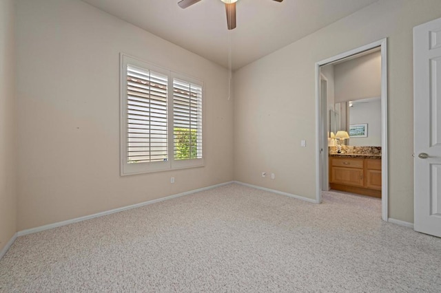 spare room with ceiling fan and light carpet