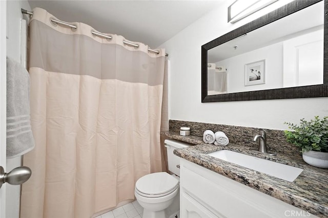 bathroom with tile patterned flooring, vanity, a shower with curtain, and toilet