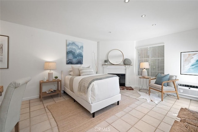 bedroom with a wall mounted AC and light tile patterned floors