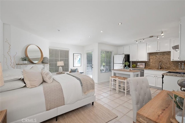 tiled bedroom with white fridge