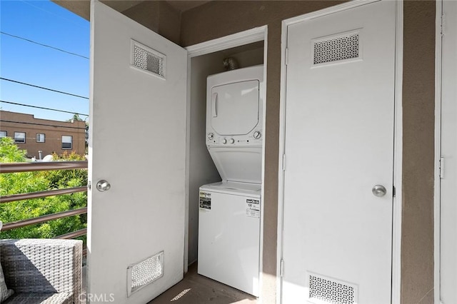 laundry area with stacked washer and clothes dryer