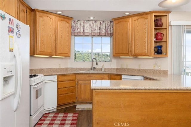 kitchen with kitchen peninsula, white appliances, sink, and dark wood-type flooring