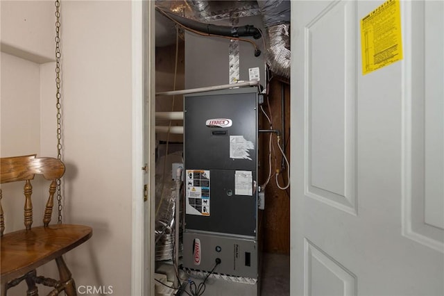 utility room featuring heating unit