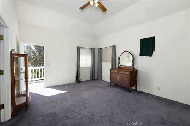 unfurnished bedroom featuring dark colored carpet, ceiling fan, and access to exterior