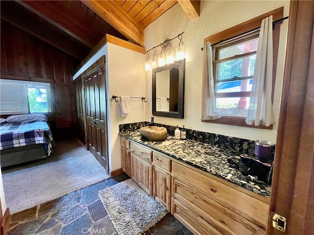 bathroom with vanity, wood ceiling, lofted ceiling with beams, and a healthy amount of sunlight