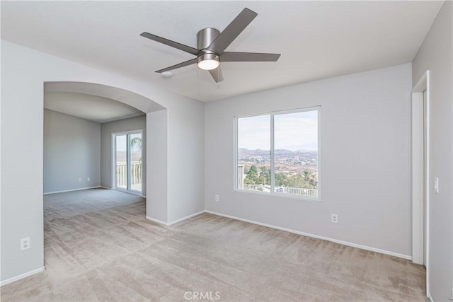 carpeted empty room featuring ceiling fan