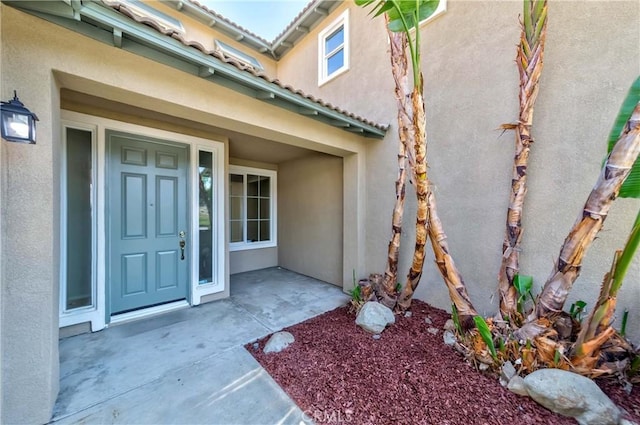 doorway to property with a patio area