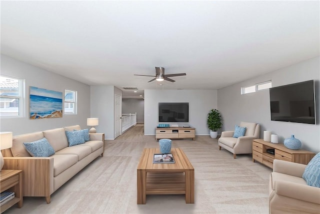 living room featuring ceiling fan and light carpet