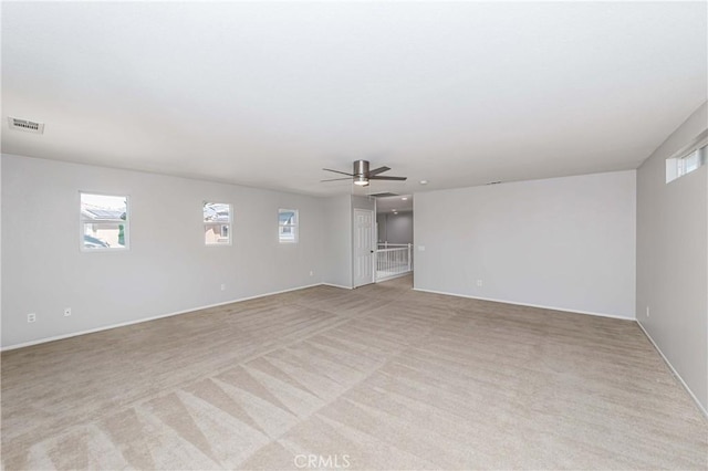 empty room with light carpet and ceiling fan