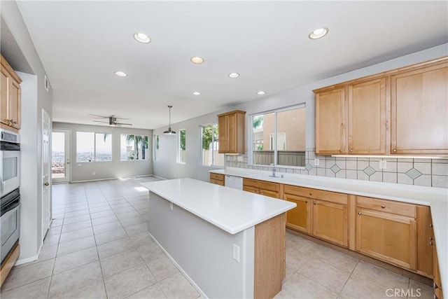 kitchen with tasteful backsplash, ceiling fan, a center island, white dishwasher, and hanging light fixtures