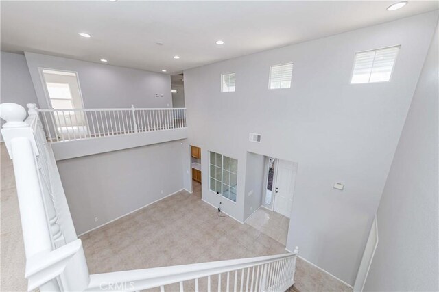 stairway featuring carpet flooring