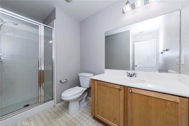 bathroom with toilet, vanity, and walk in shower