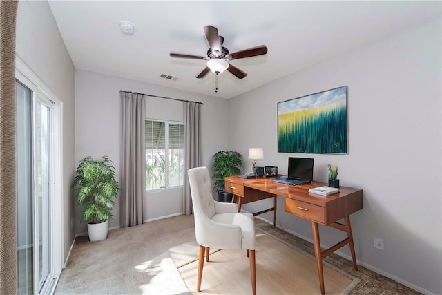 home office with ceiling fan and light colored carpet