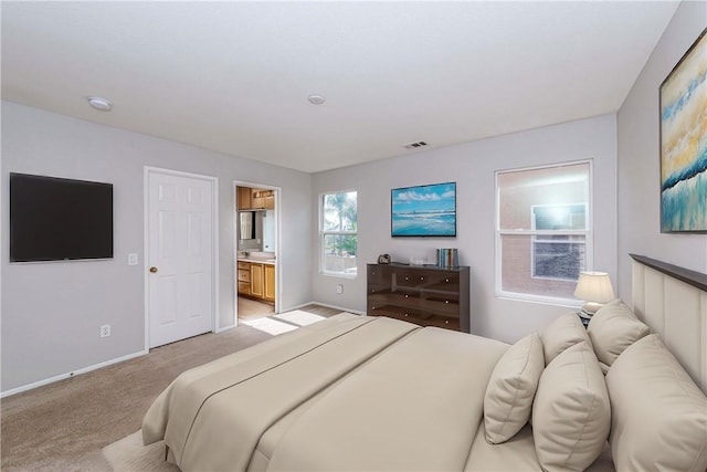 carpeted bedroom featuring ensuite bathroom