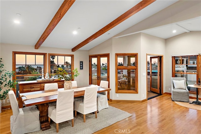 dining room with light hardwood / wood-style flooring, french doors, and vaulted ceiling with beams