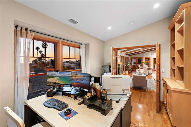 office space with lofted ceiling and light wood-type flooring