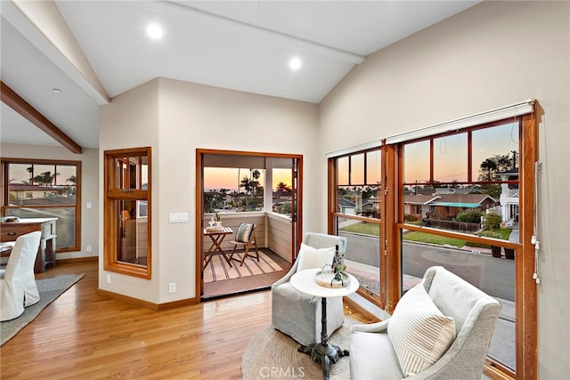 interior space featuring light hardwood / wood-style floors and lofted ceiling with beams