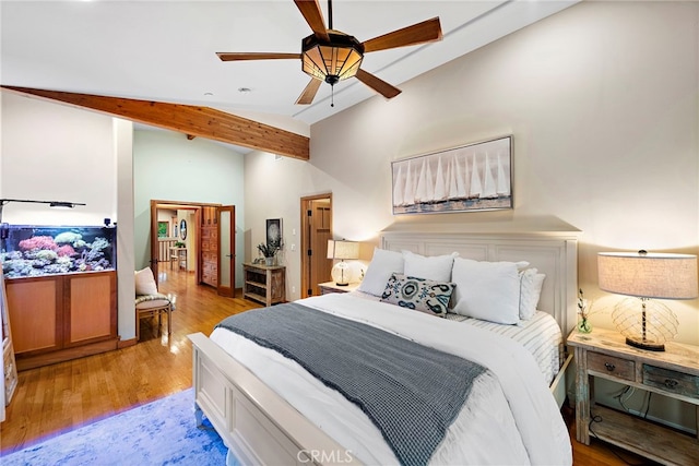 bedroom featuring light wood-type flooring, ceiling fan, and vaulted ceiling