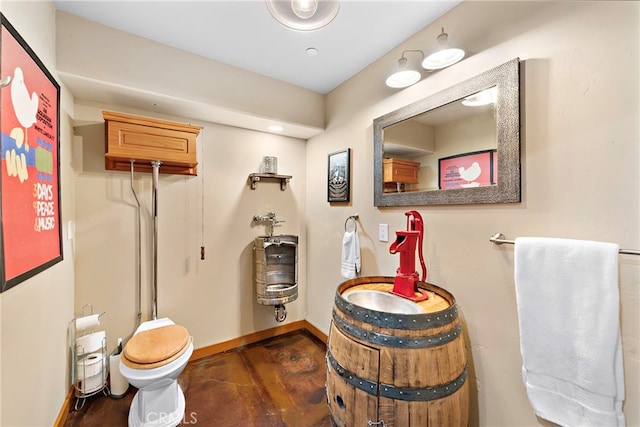 bathroom with hardwood / wood-style flooring, vanity, and toilet