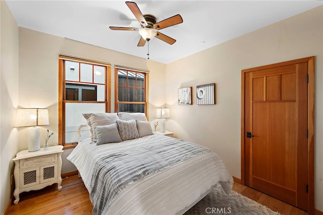 bedroom with light hardwood / wood-style floors and ceiling fan