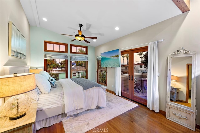 bedroom with ceiling fan, lofted ceiling, french doors, access to exterior, and hardwood / wood-style floors