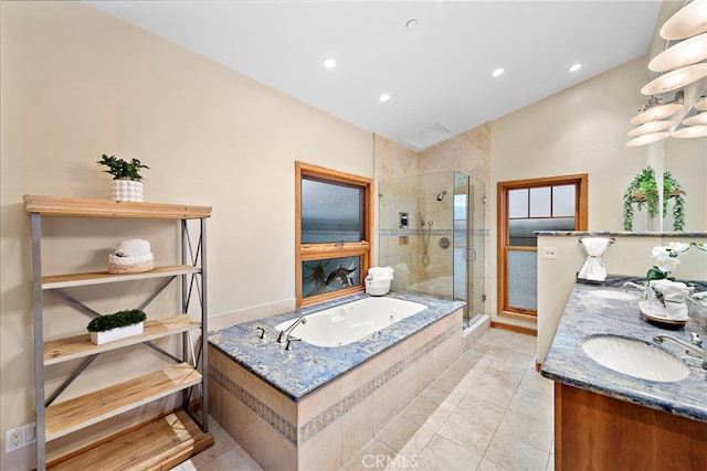 bathroom featuring plus walk in shower, tile patterned floors, and vanity