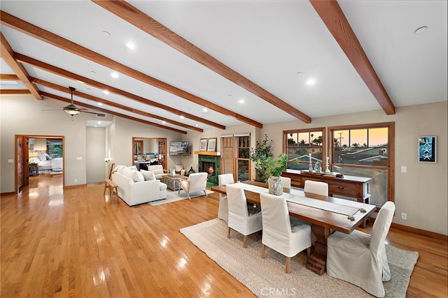 dining room with lofted ceiling with beams, ceiling fan, and light hardwood / wood-style flooring