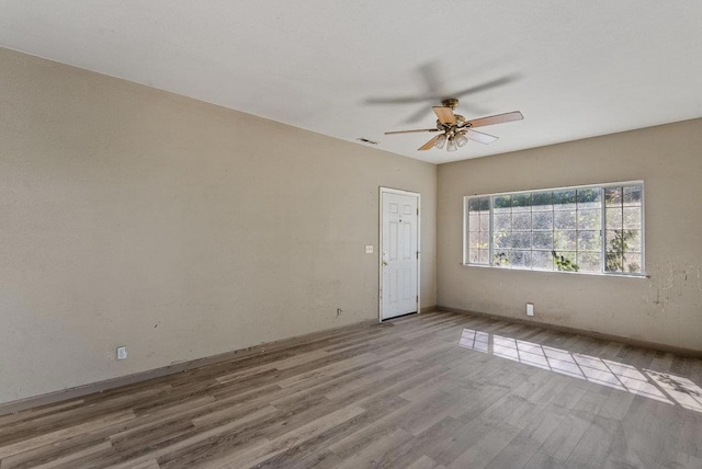 spare room featuring light wood-type flooring and ceiling fan