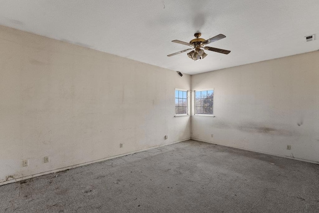 unfurnished room featuring ceiling fan and light carpet