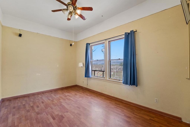 unfurnished room with ceiling fan and wood-type flooring