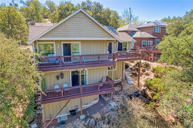 back of house featuring a wooden deck