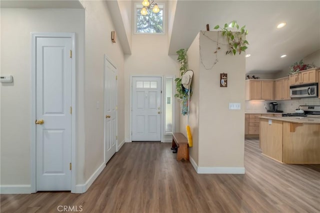 entryway featuring a notable chandelier and light hardwood / wood-style flooring